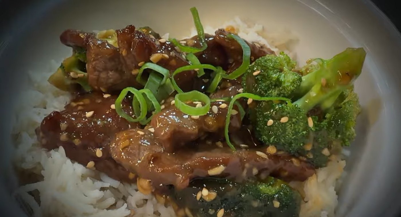 Mongolian beef and broccoli over rice with sesame seeds and green onion